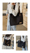 Stylish black canvas tote bag with detachable shoulder strap